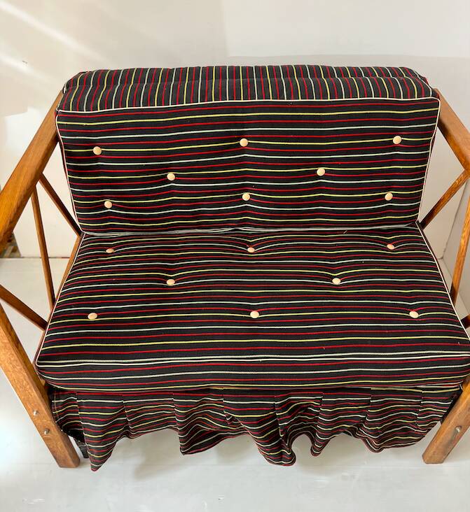 Two-seater bench convertible into a single bed.