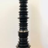 A brutalist black pepper mill
