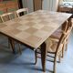 Oak dining table with a checkerboard top and extensions.