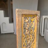 Rectangular Indonesian construction element with blue and yellow plant in carved wood
