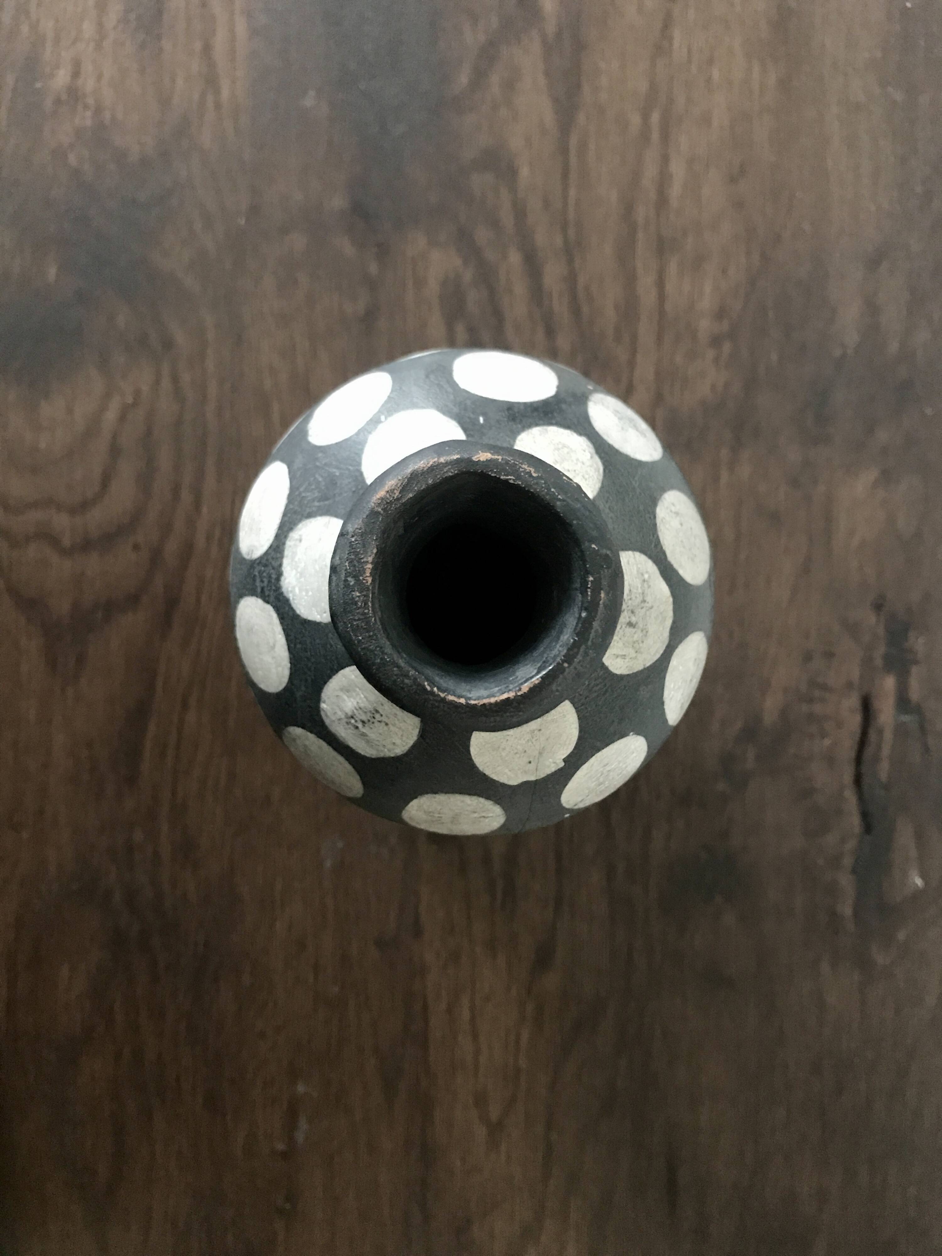 Terracotta vase painted with polka dots