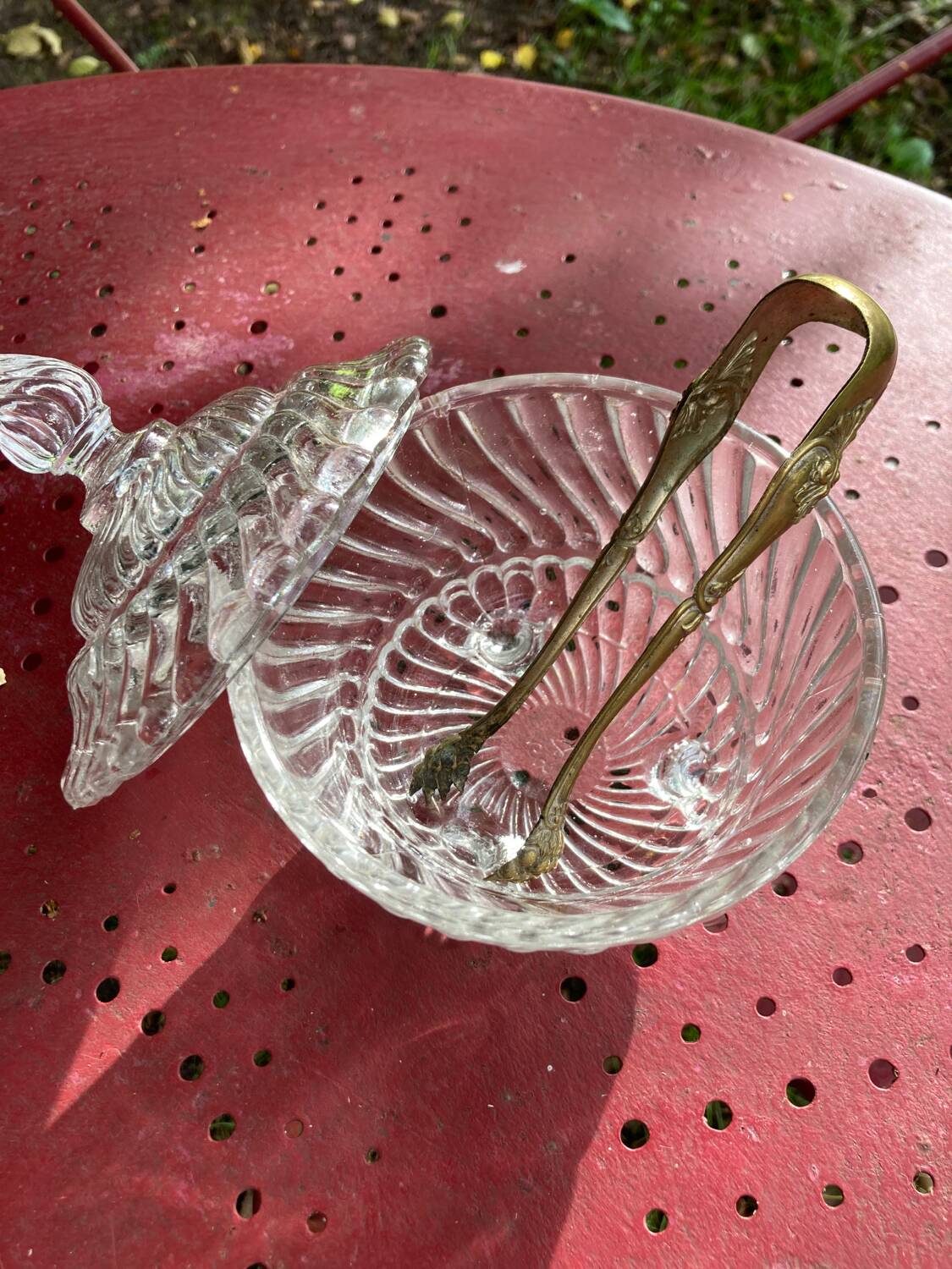 Glass sugar bowl and brass tongs