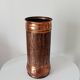 Vintage brutalist umbrella stand in hammered copper with a wood effect.