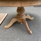 Round dining table with a central pedestal, extendable, stripped in solid walnut with 2 extensions.
