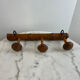 Wooden coat rack with three ball hooks.