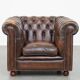 Cowhide English Chesterfield armchair with ball legs and timeless finish