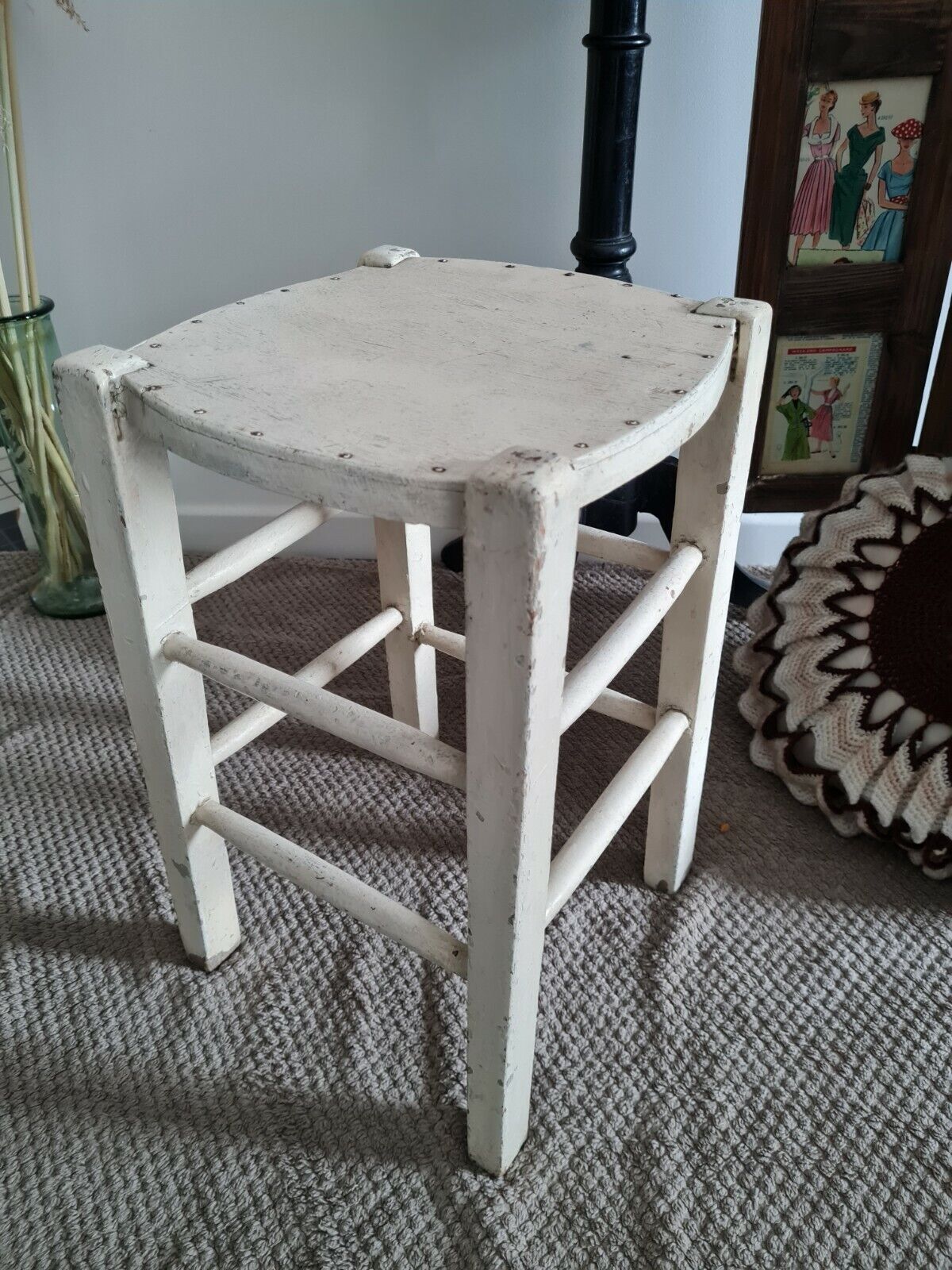 Vintage wooden stool with white peeling paint