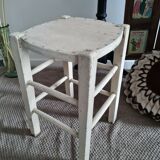 Vintage wooden stool with white peeling paint