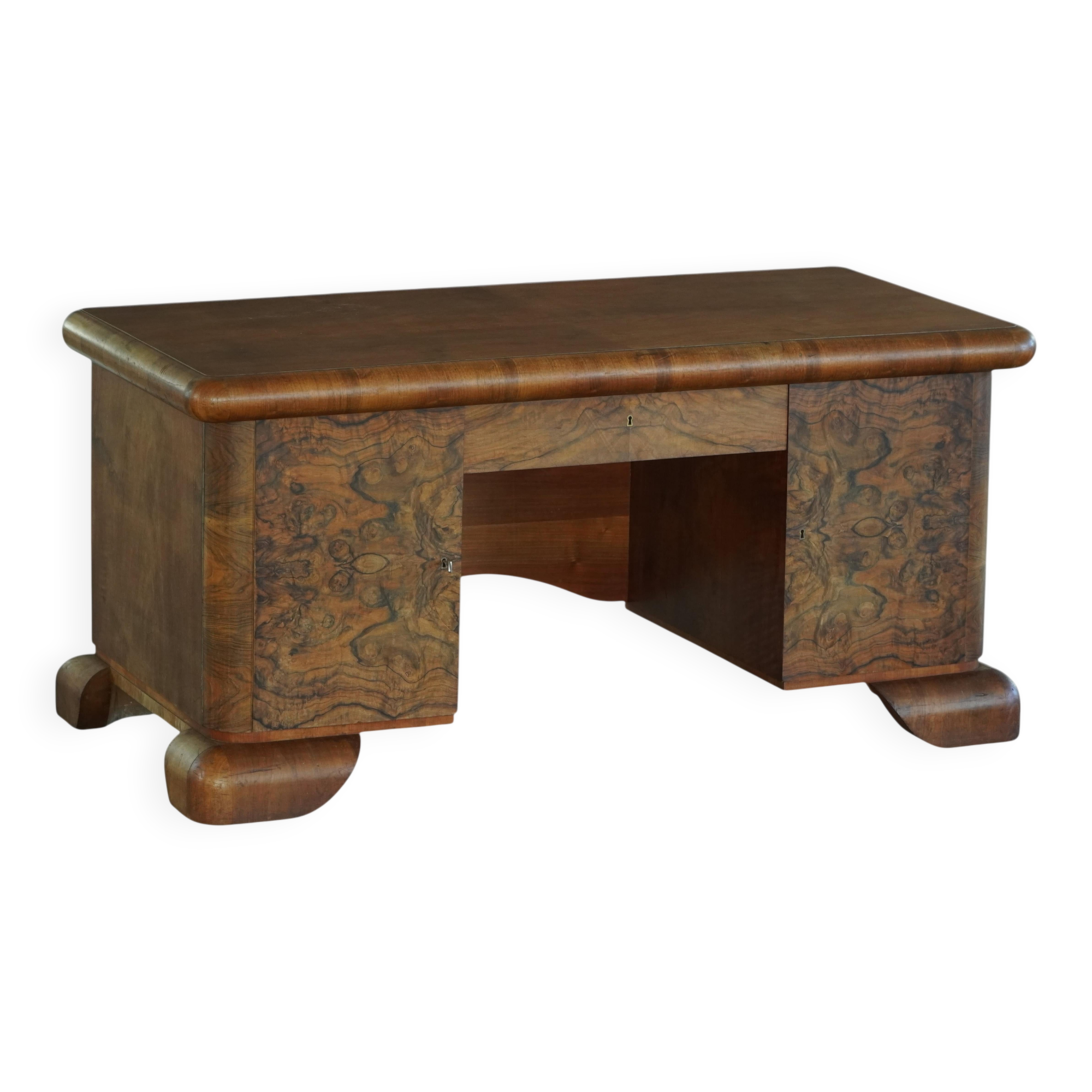 Art Deco desk, sculptural and expressive, in walnut, made by a French cabinetmaker, 1930s.