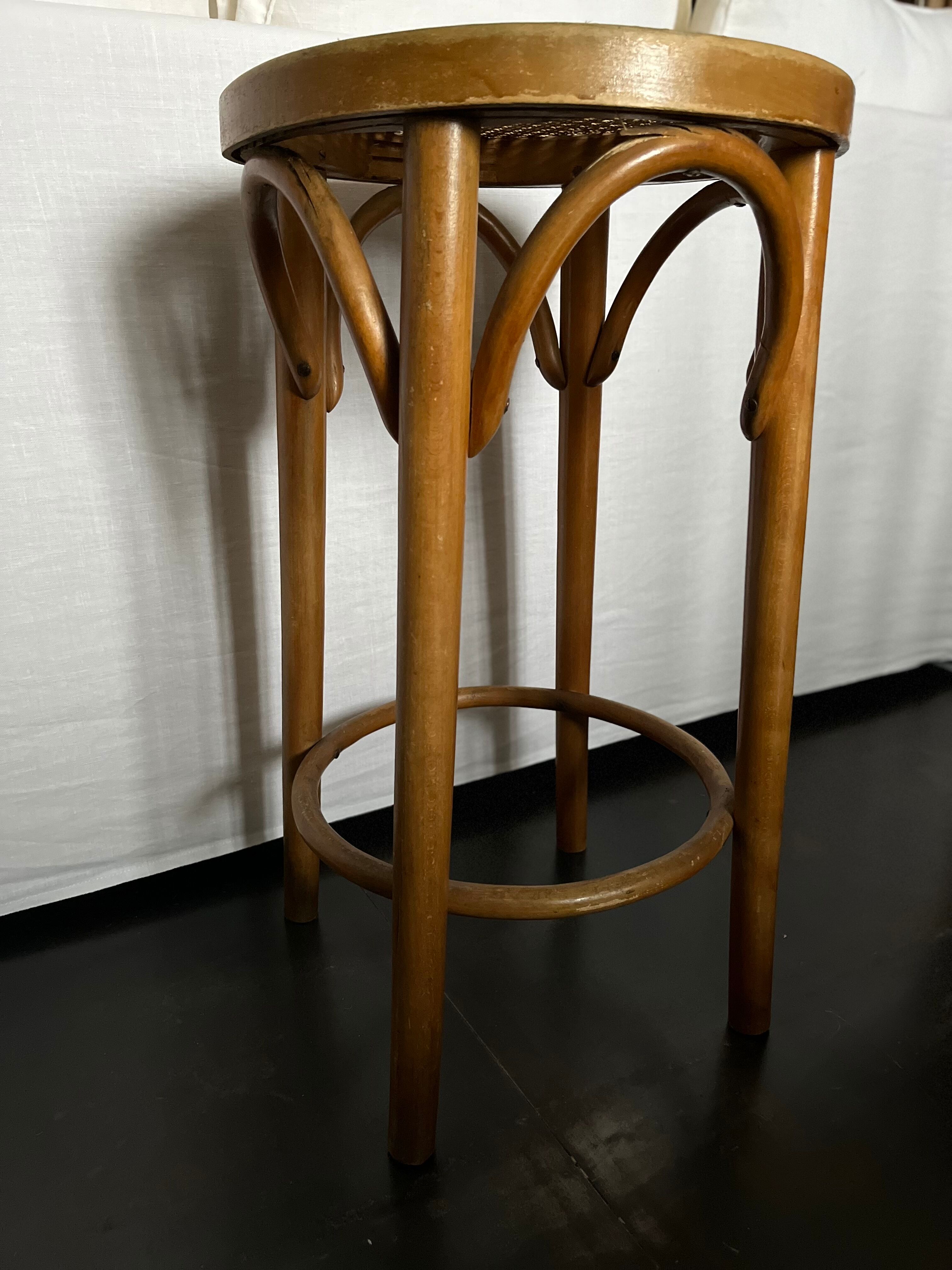 Curved wooden stool and cannage