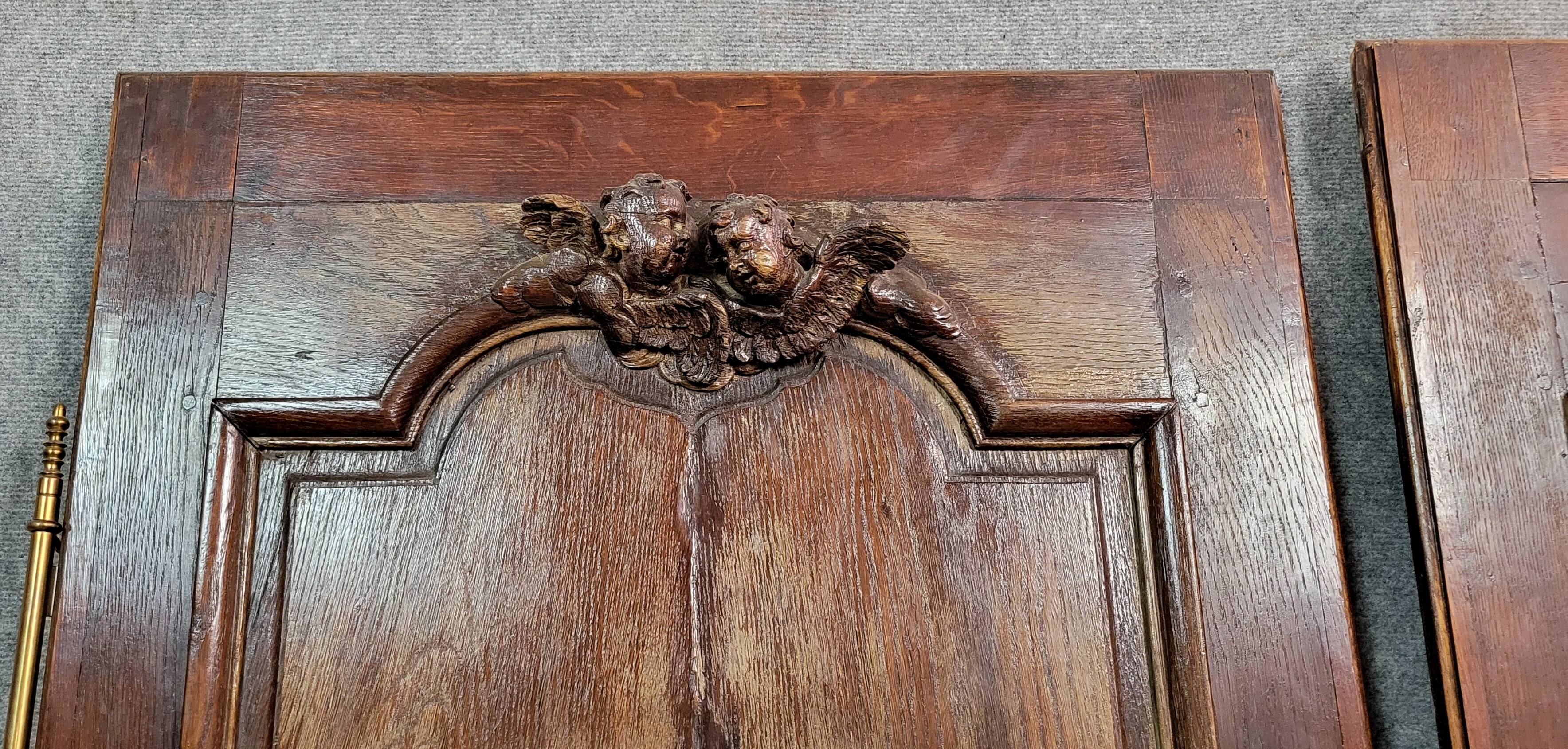 Pair of 18th century oak woodwork castle doors with putti