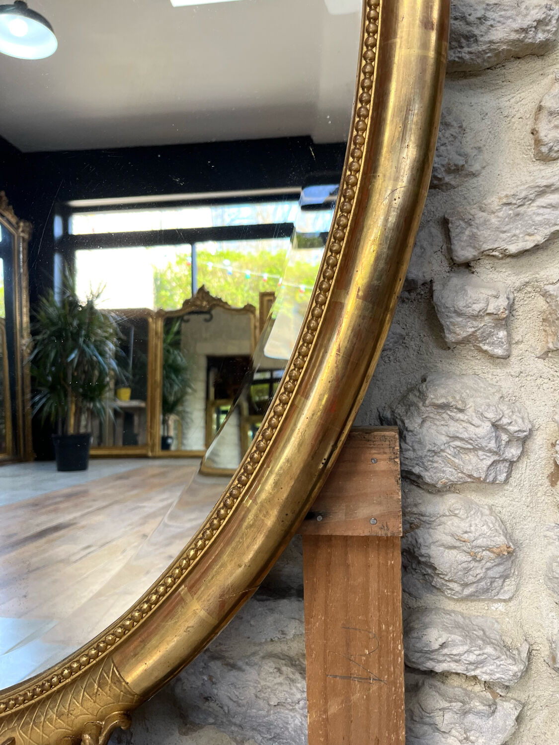 Oval mirror with pediment, beaded gilded with gold leaf