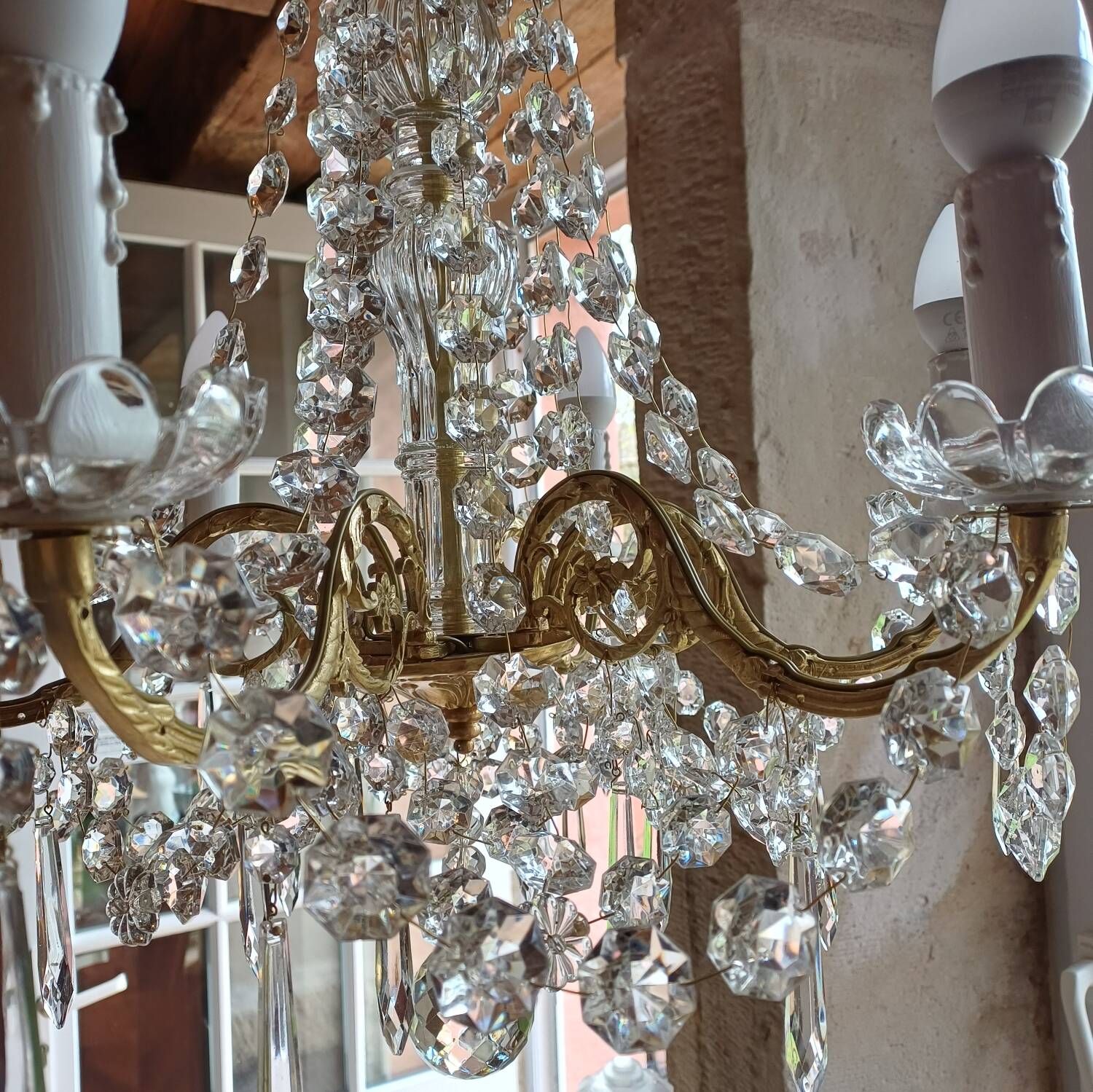 Antique chandelier with pendants in bronze and crystal.