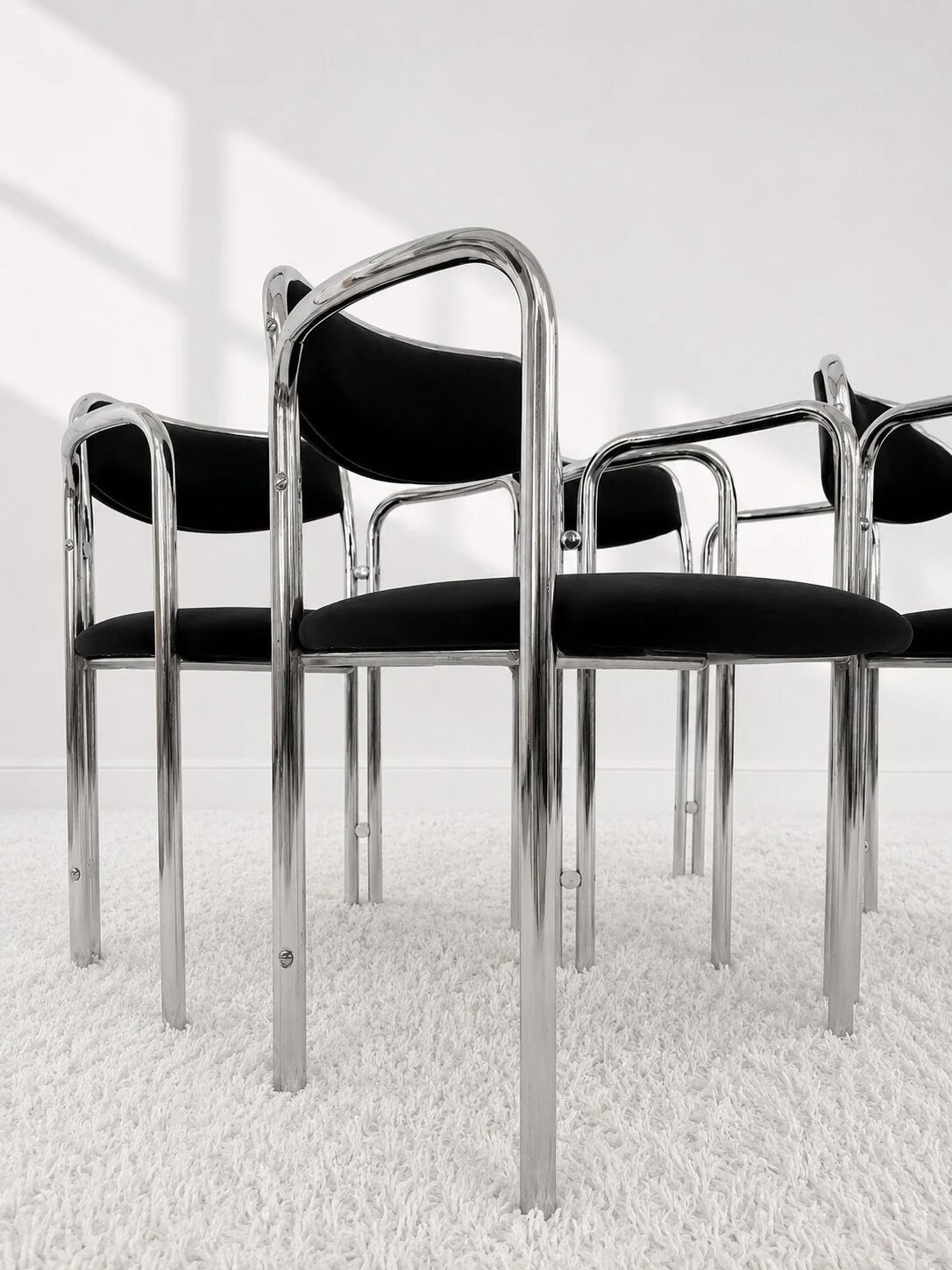 Vintage chairs with double chrome structure and black velvet. 70s