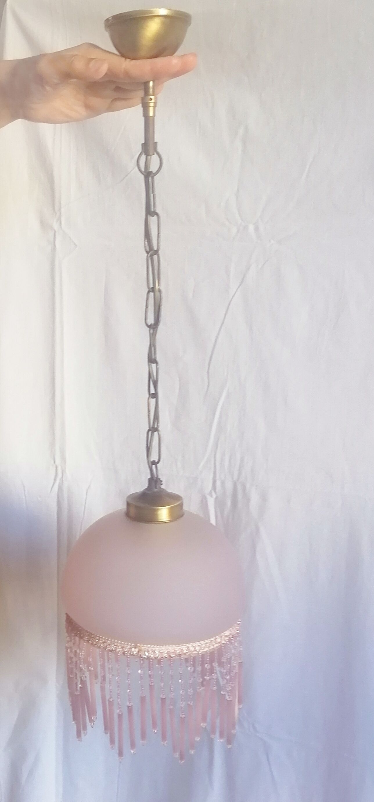 Hanging bell and pink glass garland