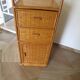 Storage column, wooden bookshelf and woven rattan.