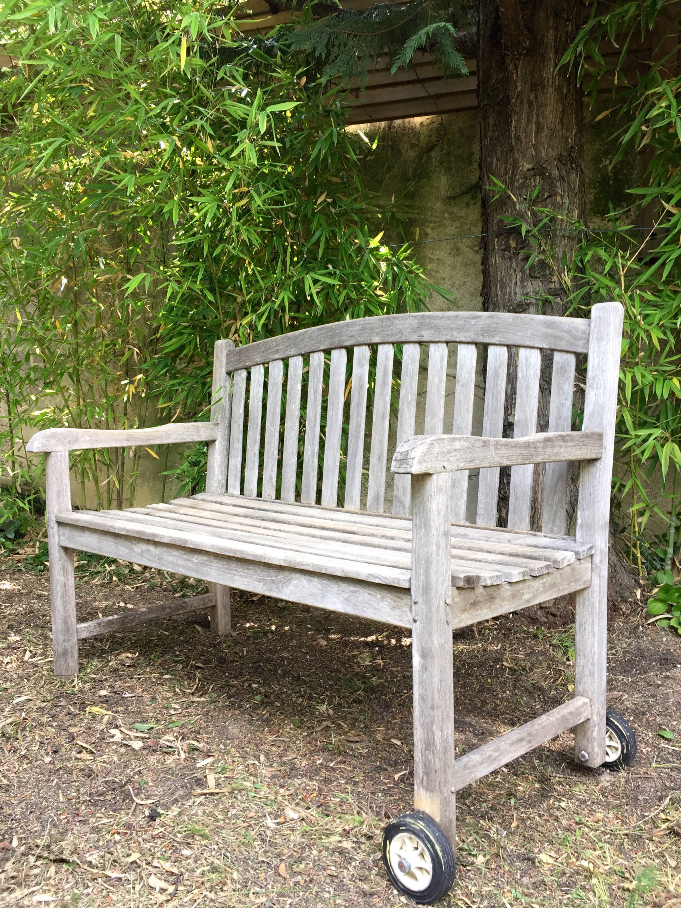 Vintage wooden garden bench with wheels