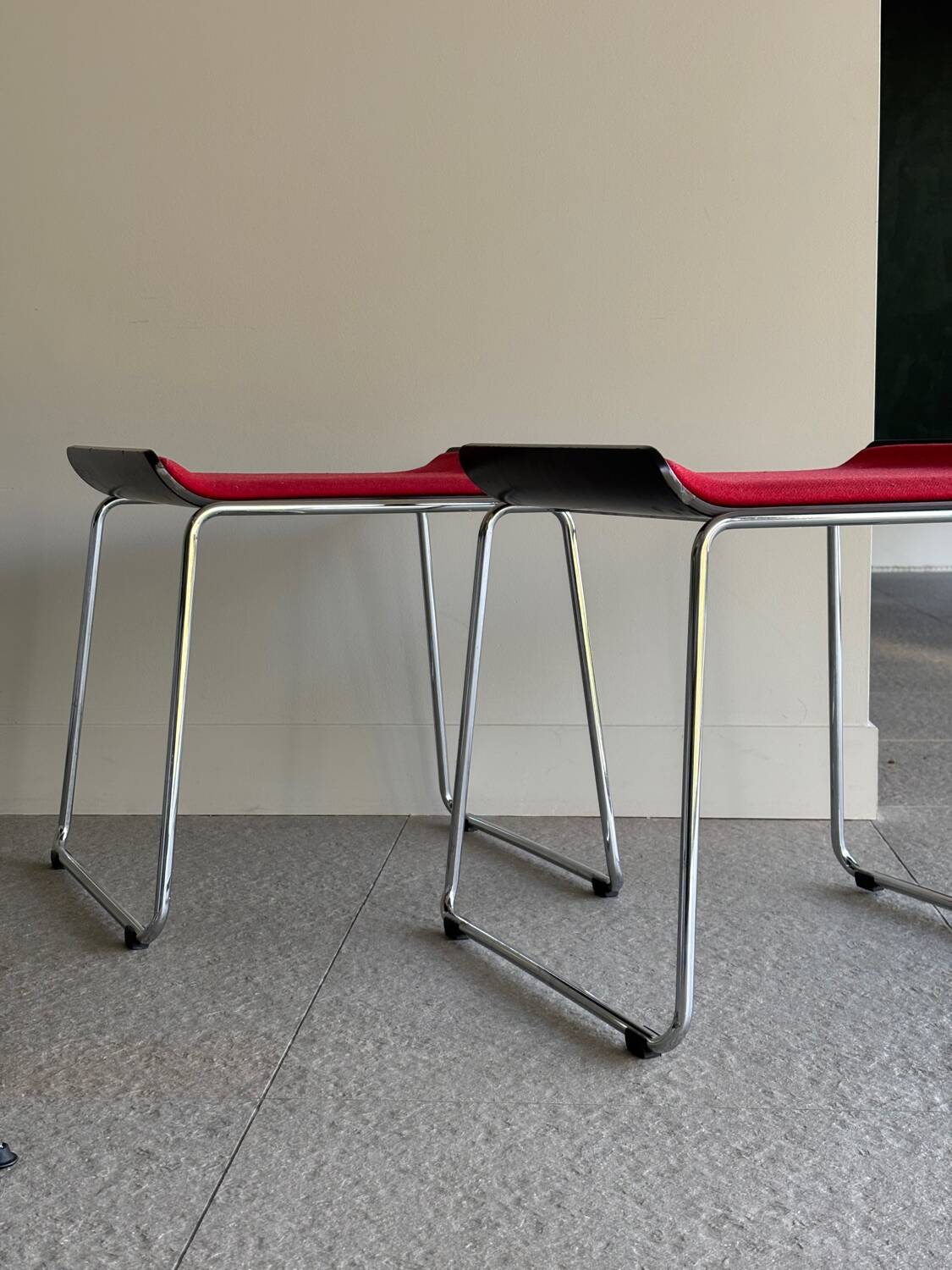 Pair of minimalist stools in red fabric with chrome legs