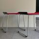 Pair of minimalist stools in red fabric with chrome legs