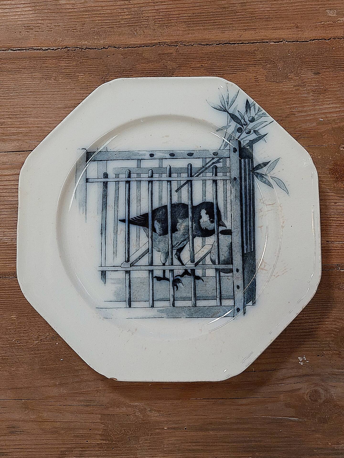 Set of three ironstone plates decorated with birds.