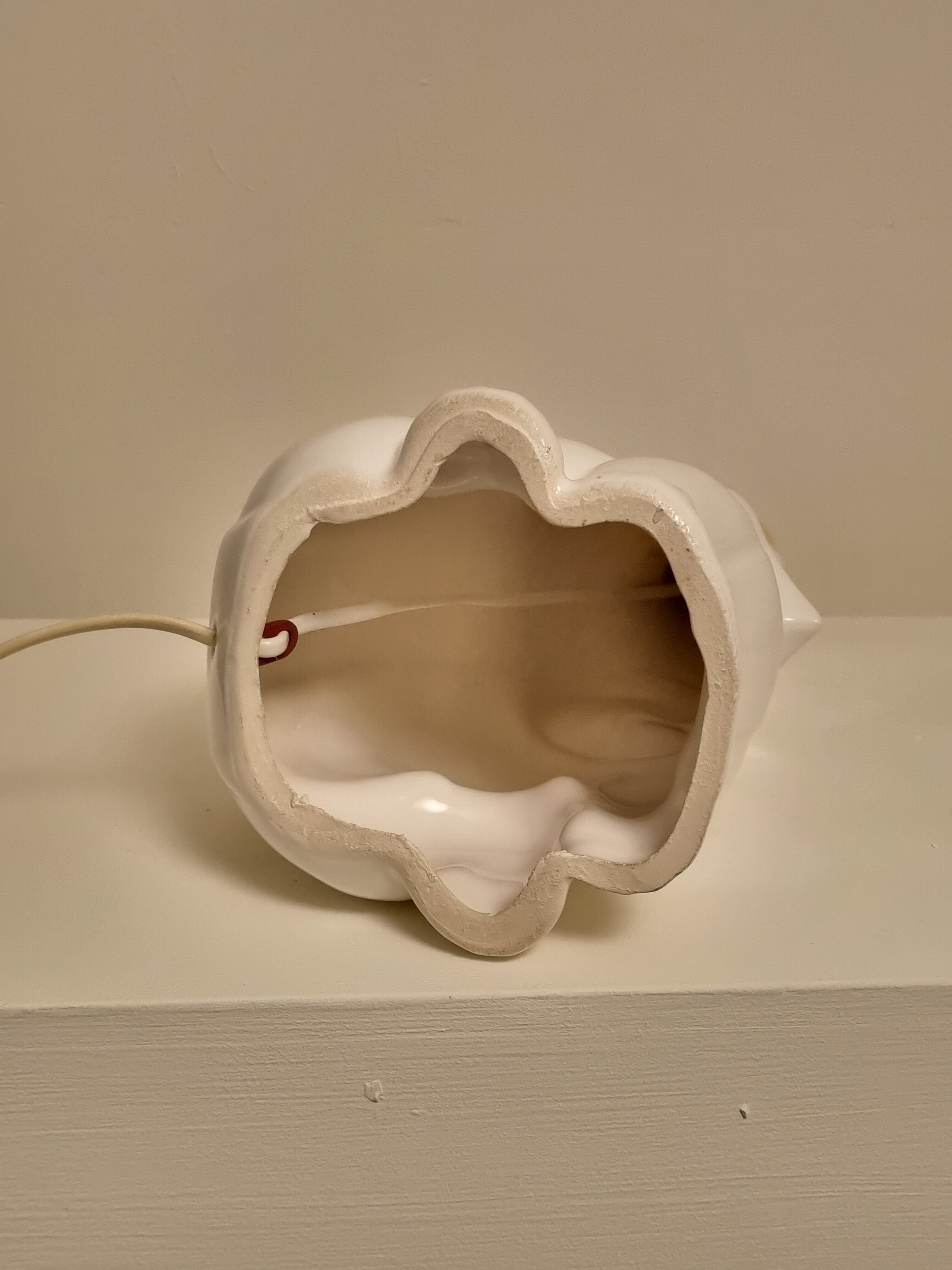 White ceramic table lamp, an elephant holding a lighted ball