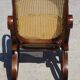 Vintage wooden rocking chair with caning
