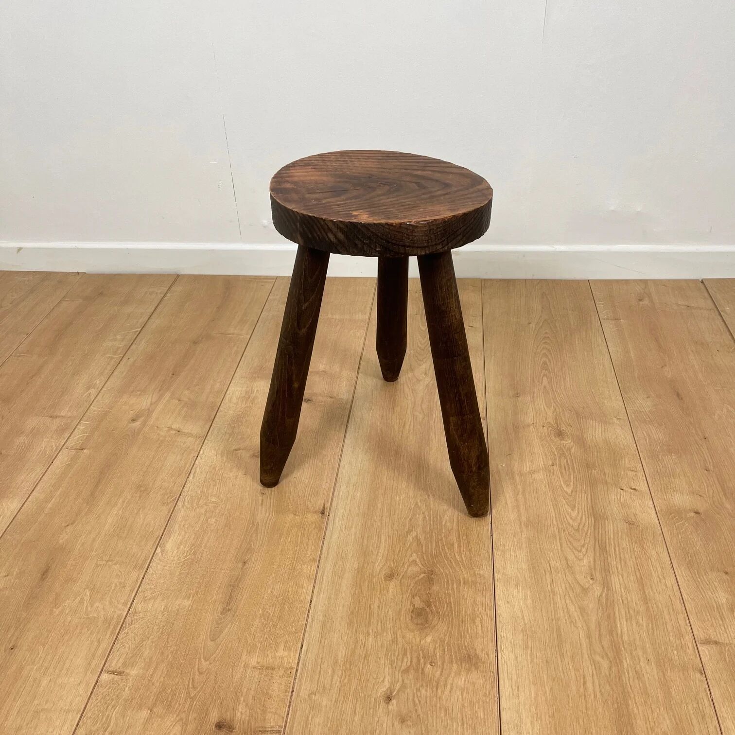 Petit tabouret tripode brutaliste en bois massif