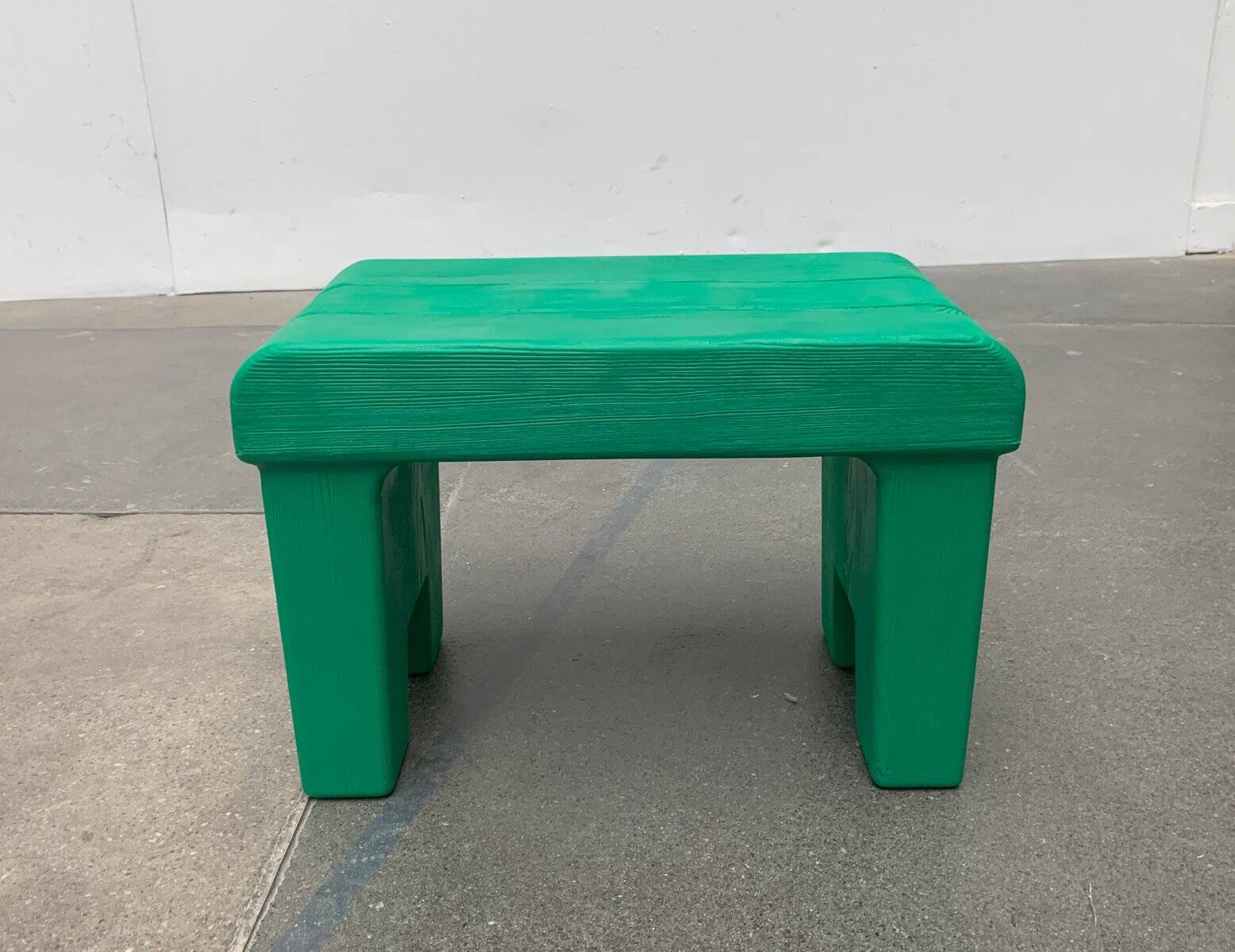 Postmodern plastic stool with a wood effect.