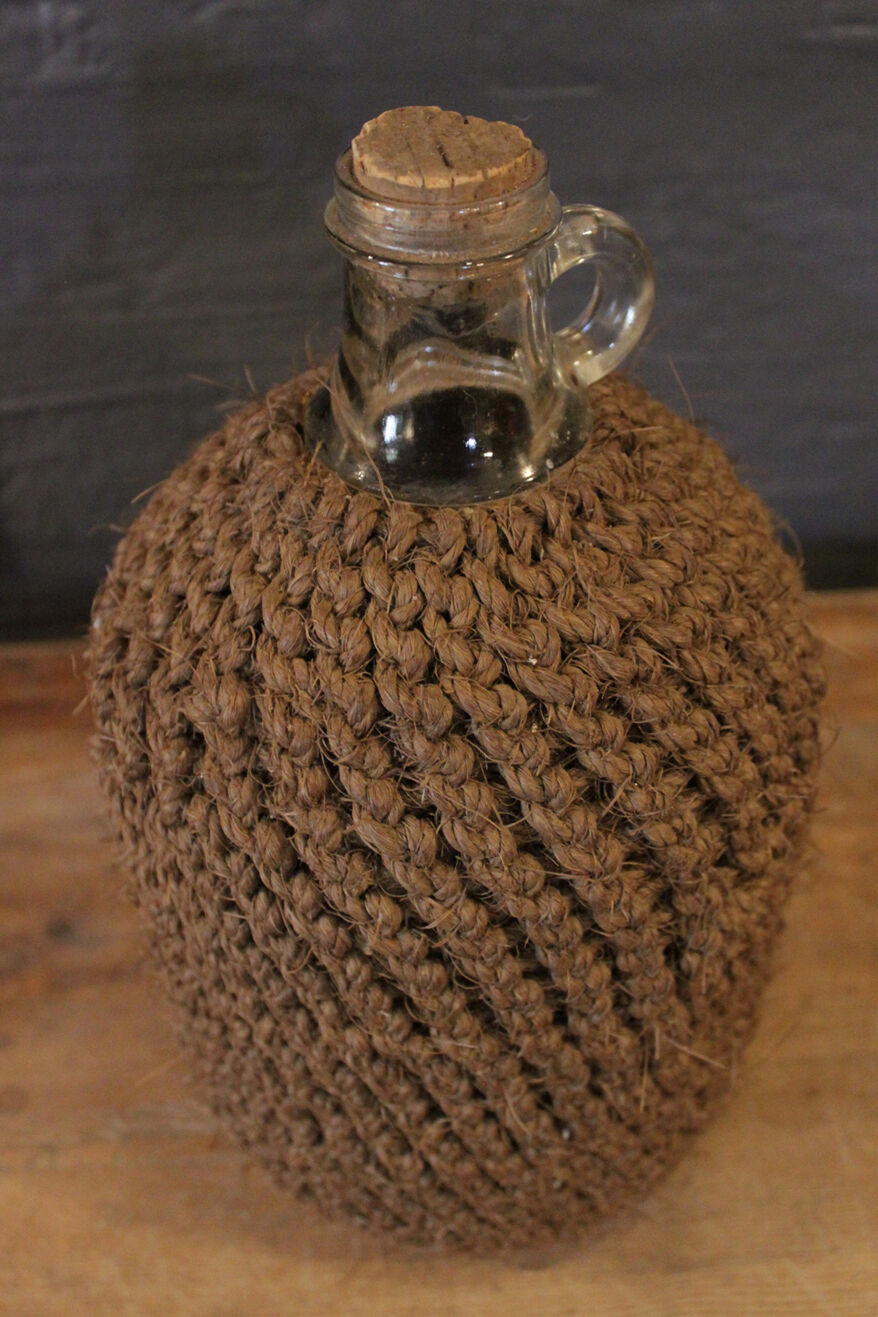 Cylinder glass surrounded by rope