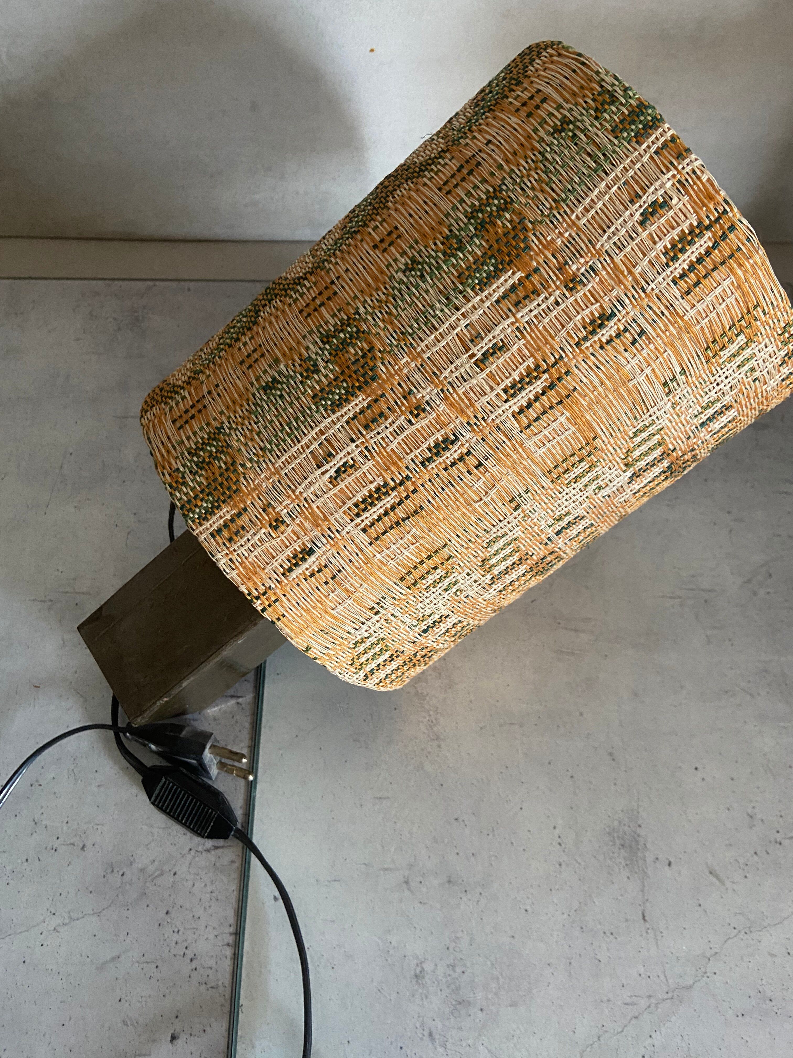 Small modernist table lamp with hand-woven shade.