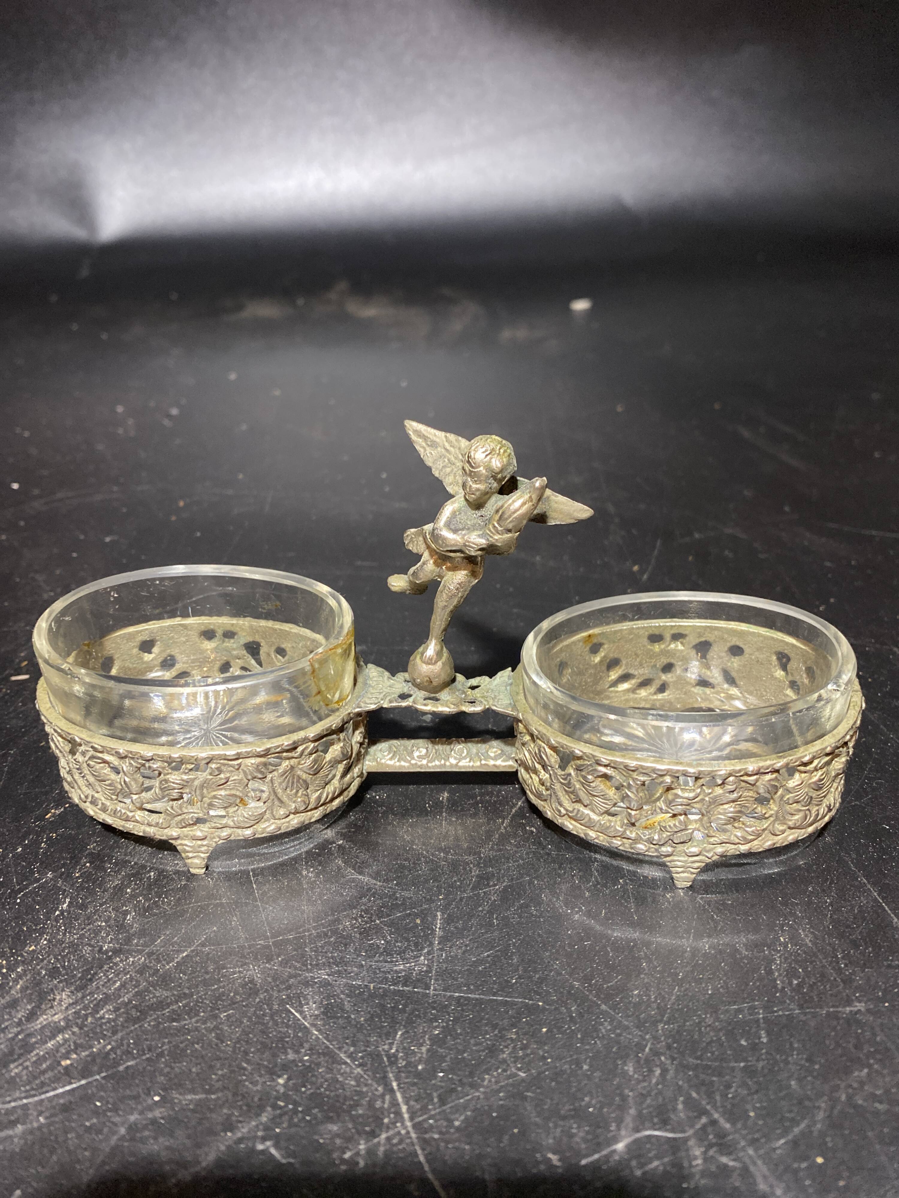 Spice centerpiece and serving spoon topped with a brass cherub