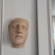 Wall sculpture of the face of the Venus de Milo in plaster.