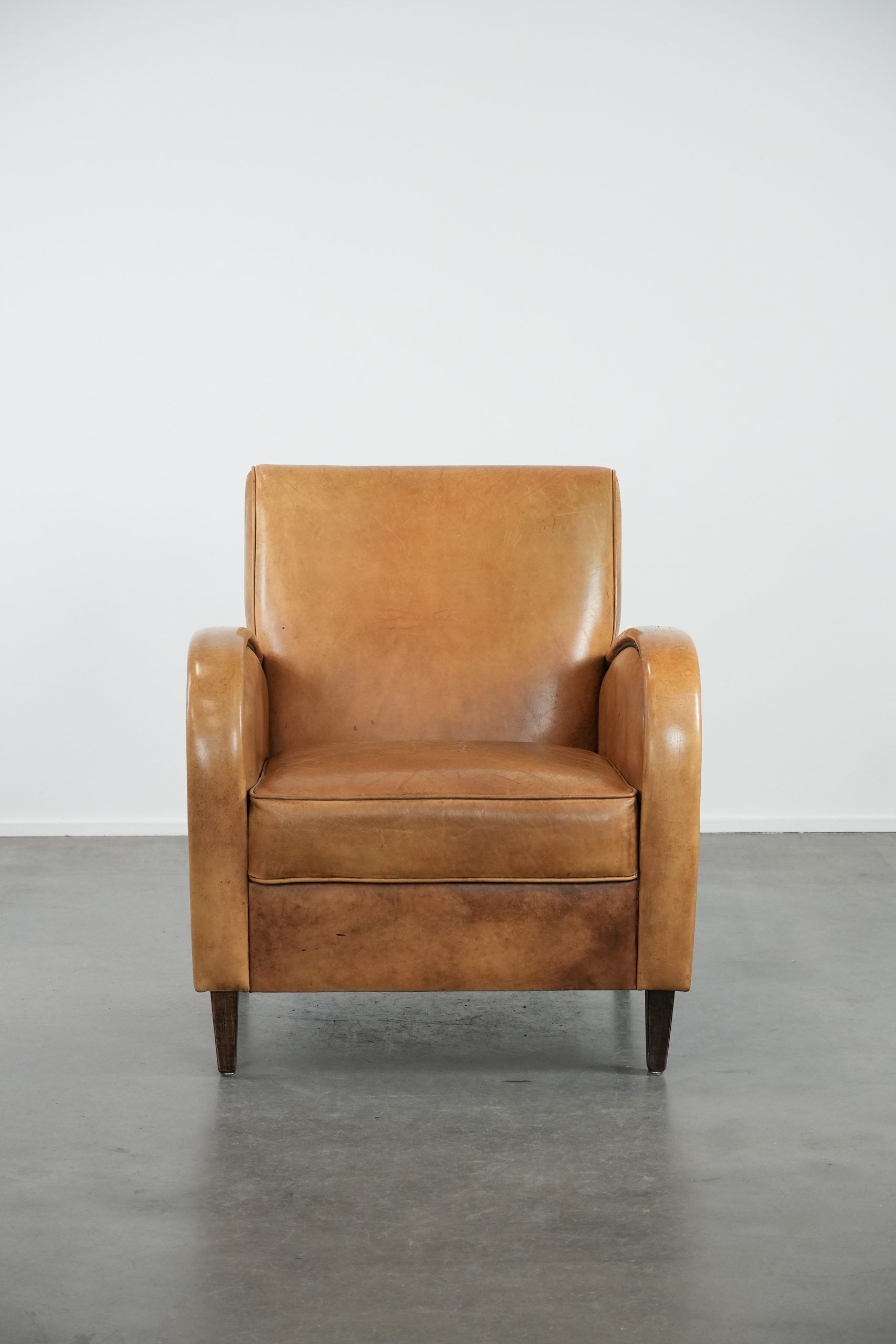 Luxury armchair made of cowhide leather with a beautiful warm colour scheme