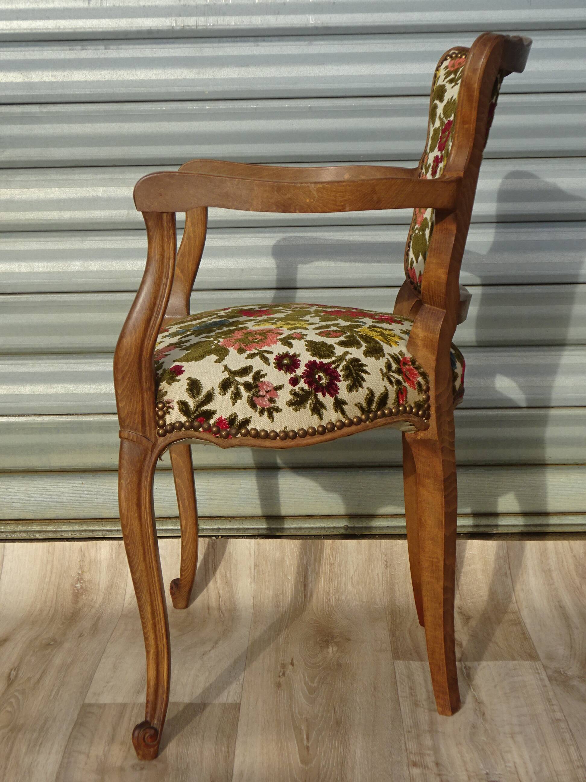 Convertible armchair with brocade fabric and floral patterns.