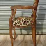Convertible armchair with brocade fabric and floral patterns.