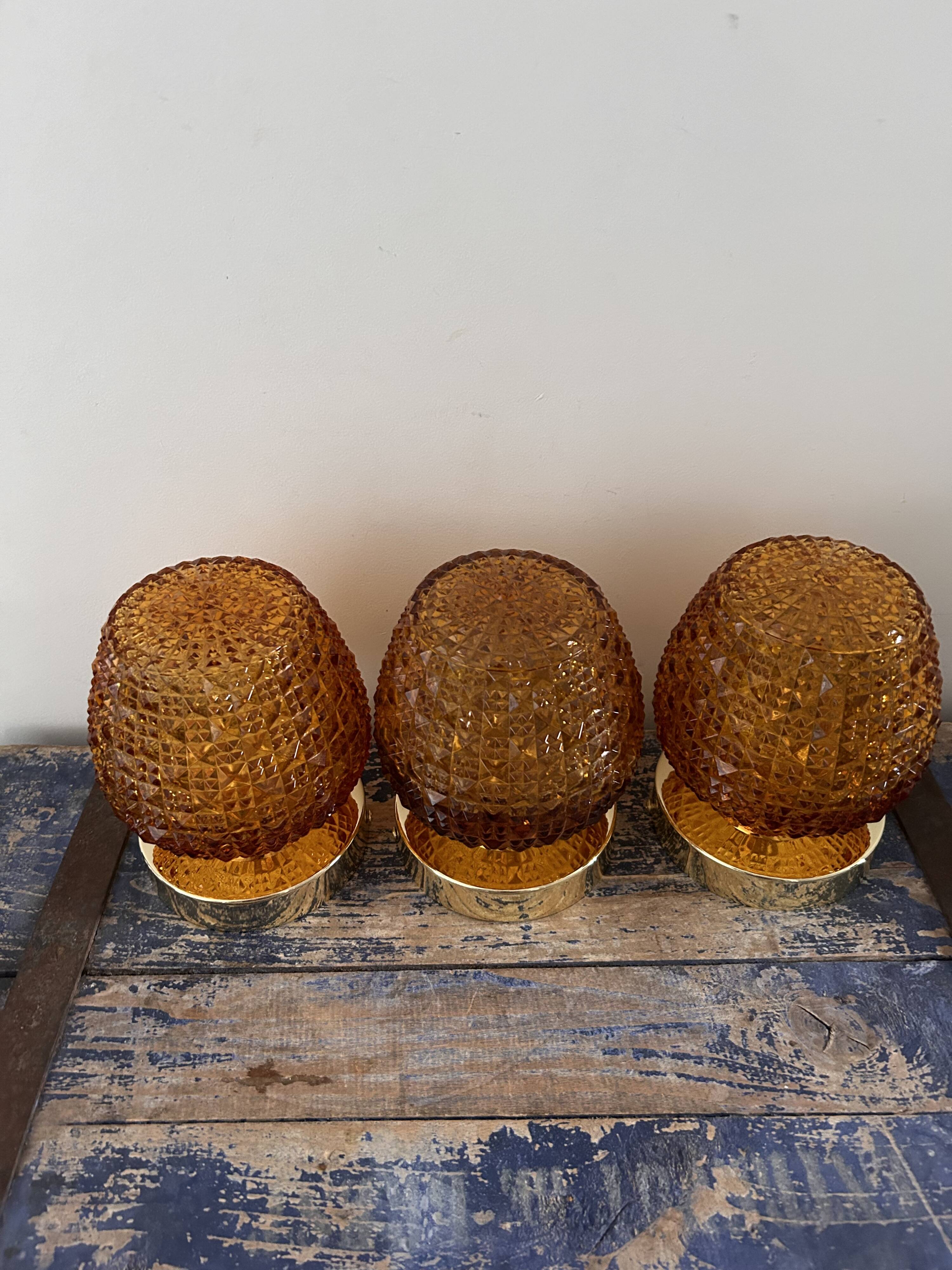 Set of three vintage wall or ceiling lights in amber chiseled glass