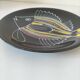 Black faience plate with stylised fish, Ty Breiz spirit from the 1960s.