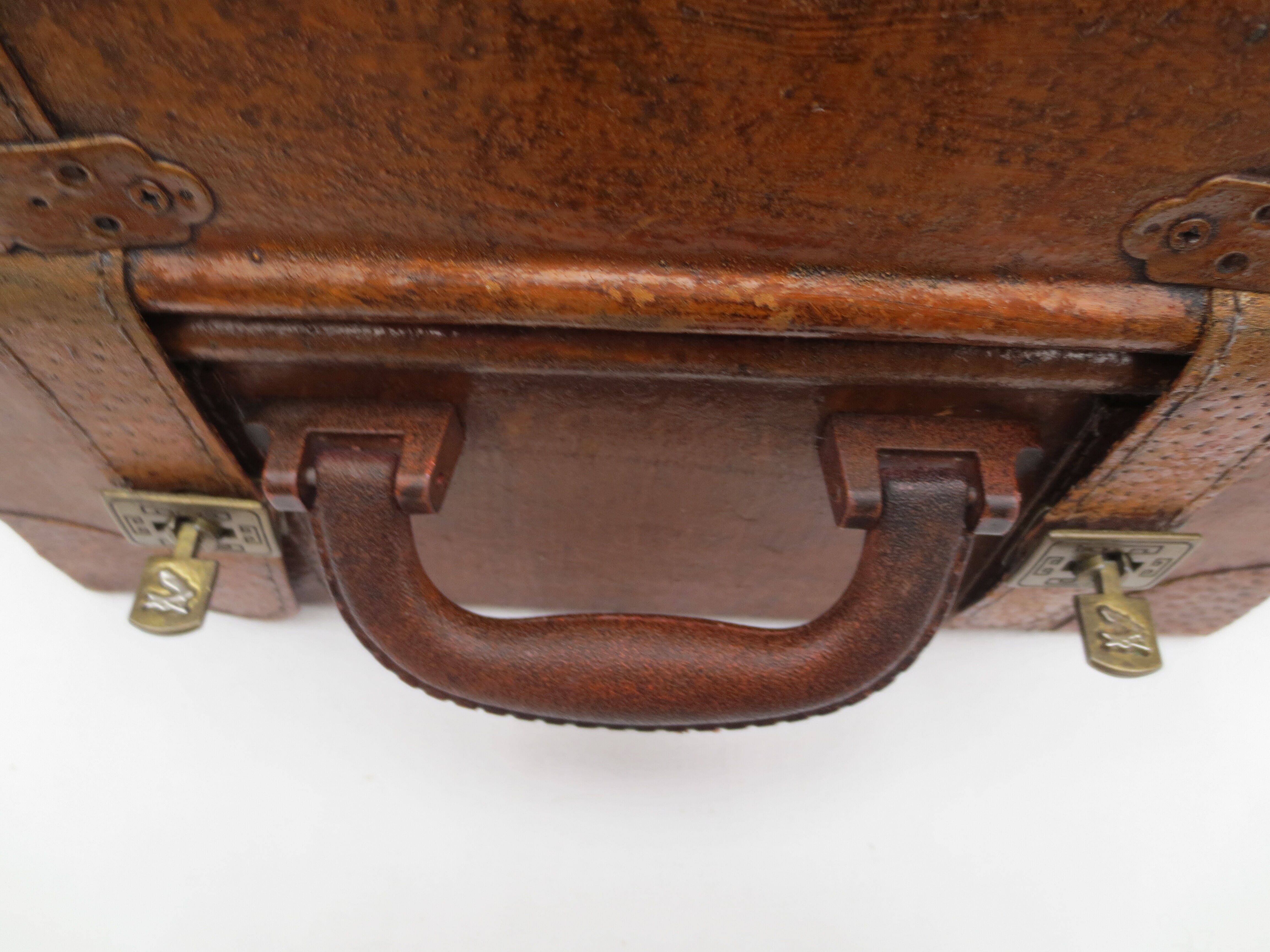 Rectangular wooden suitcase covered with leather