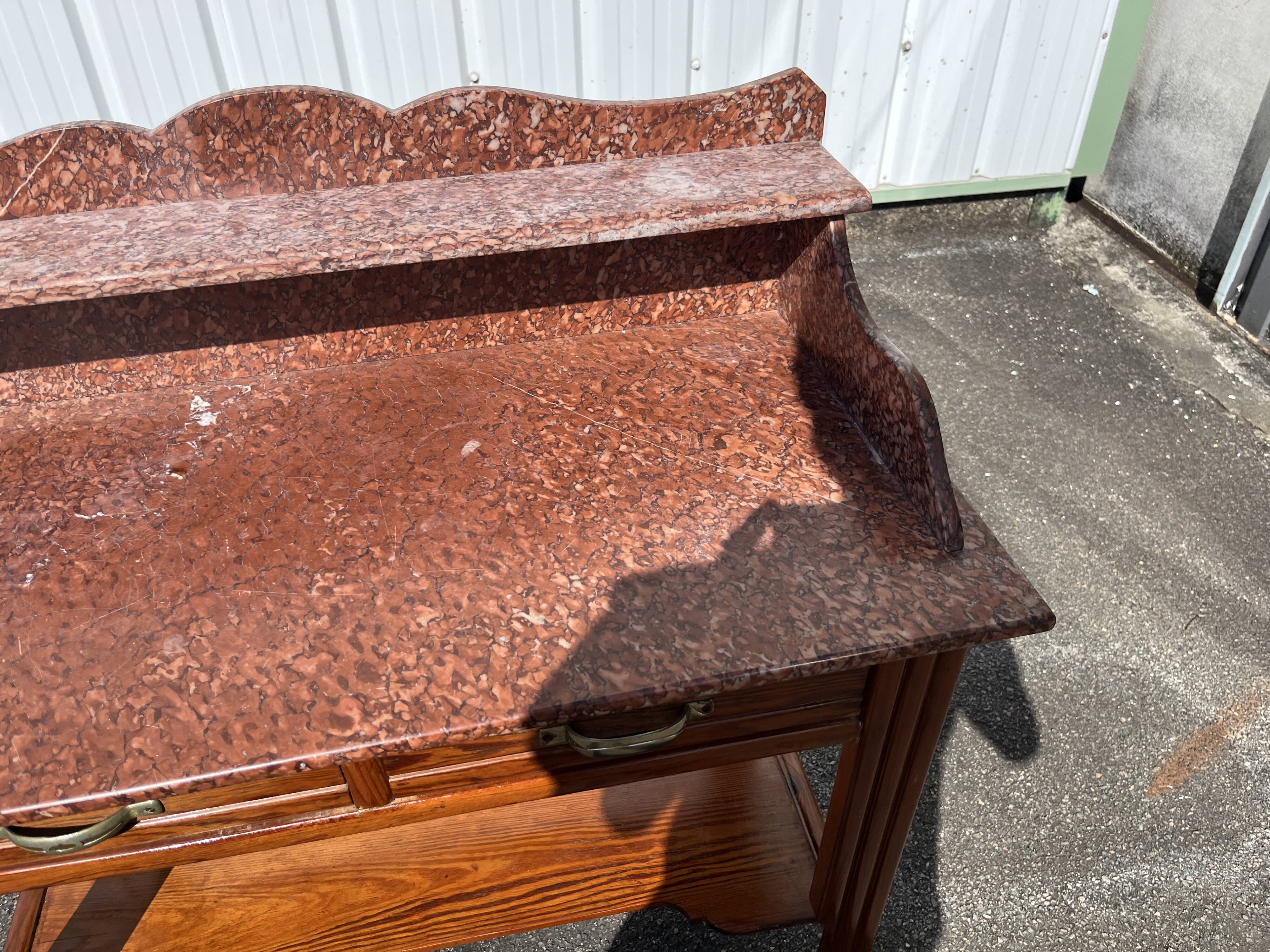 Antique wooden and red marble bathroom cabinet