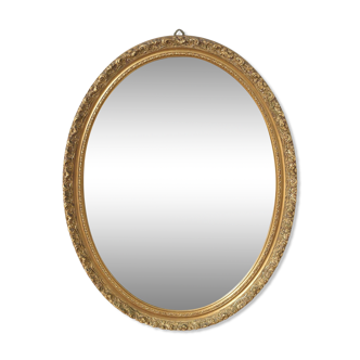 Beveled oval mirror and gilded wood frame