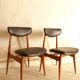 Pair of modernist Scandinavian chairs in teak and black faux leather.