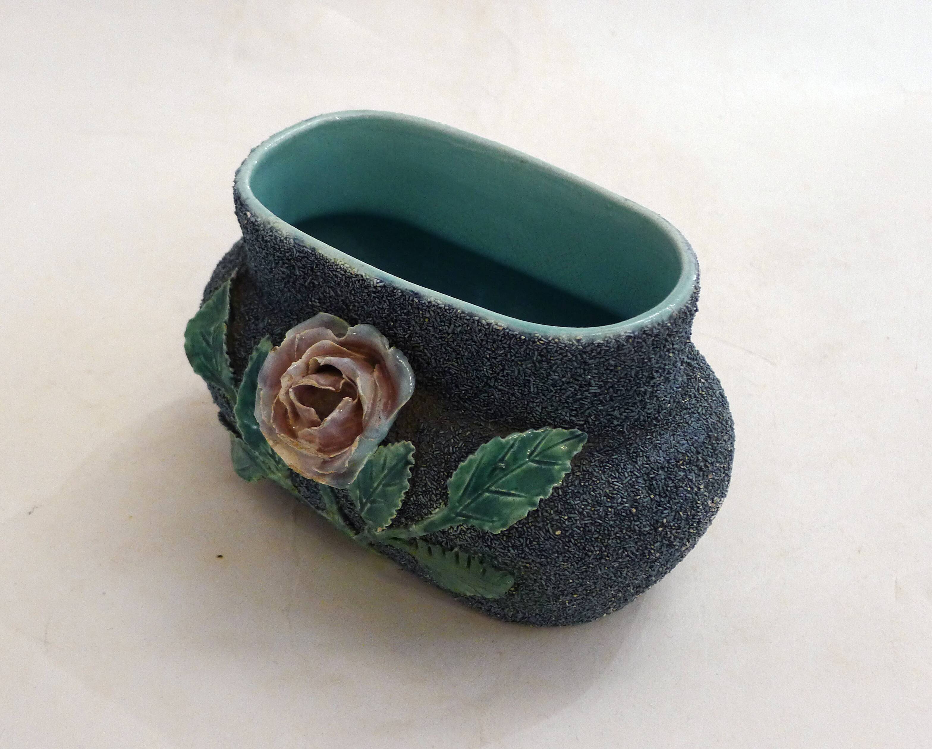Antique jardinière with rose design in barbotine pottery.