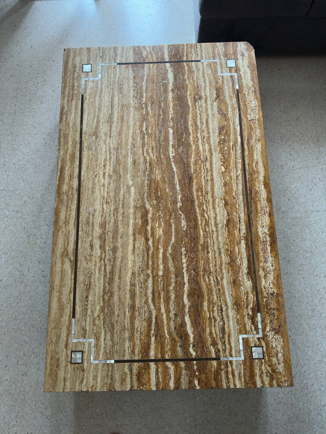 Coffee table in travertine with mother-of-pearl inlays.