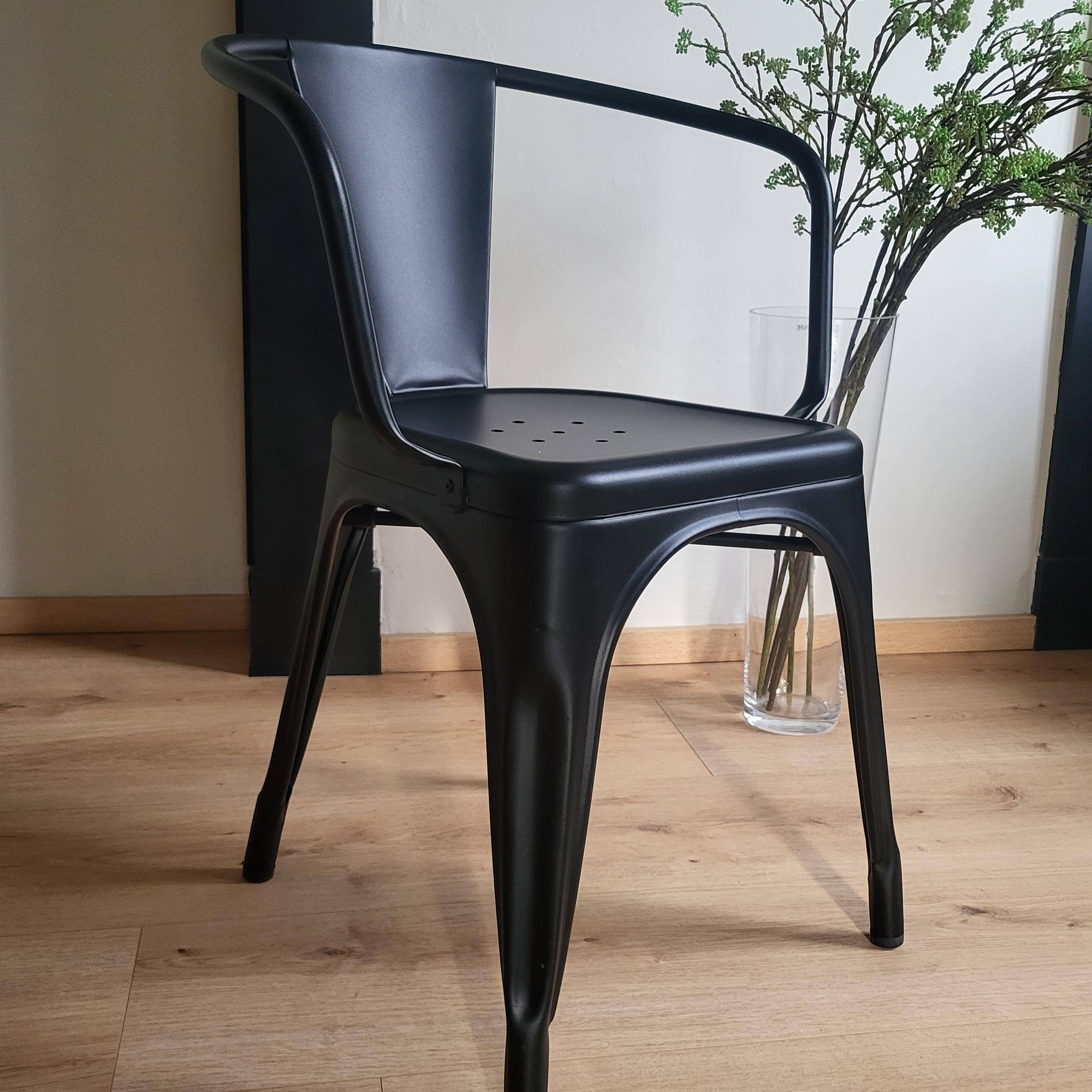 Black Tolix chair with armrests