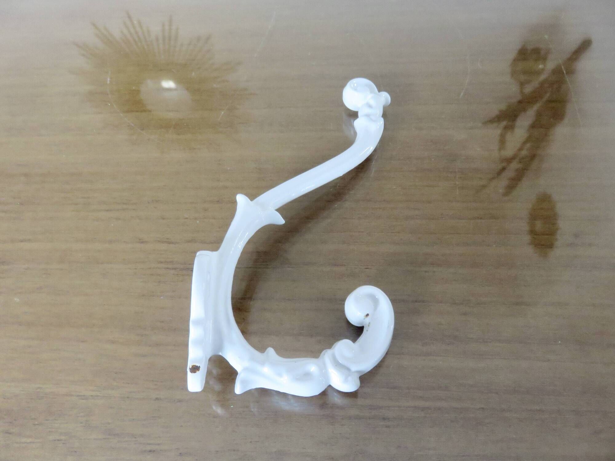 Pair of Art Deco white cast iron coat hooks from the 1930s and 1940s