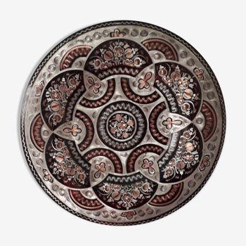 Oriental dish in chiseled red copper