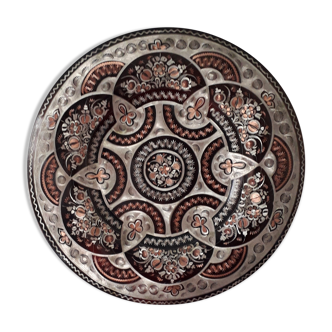 Oriental dish in chiseled red copper