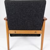 Easy chair with stool in teak and dark wool fabric of danish design from the 1960s.