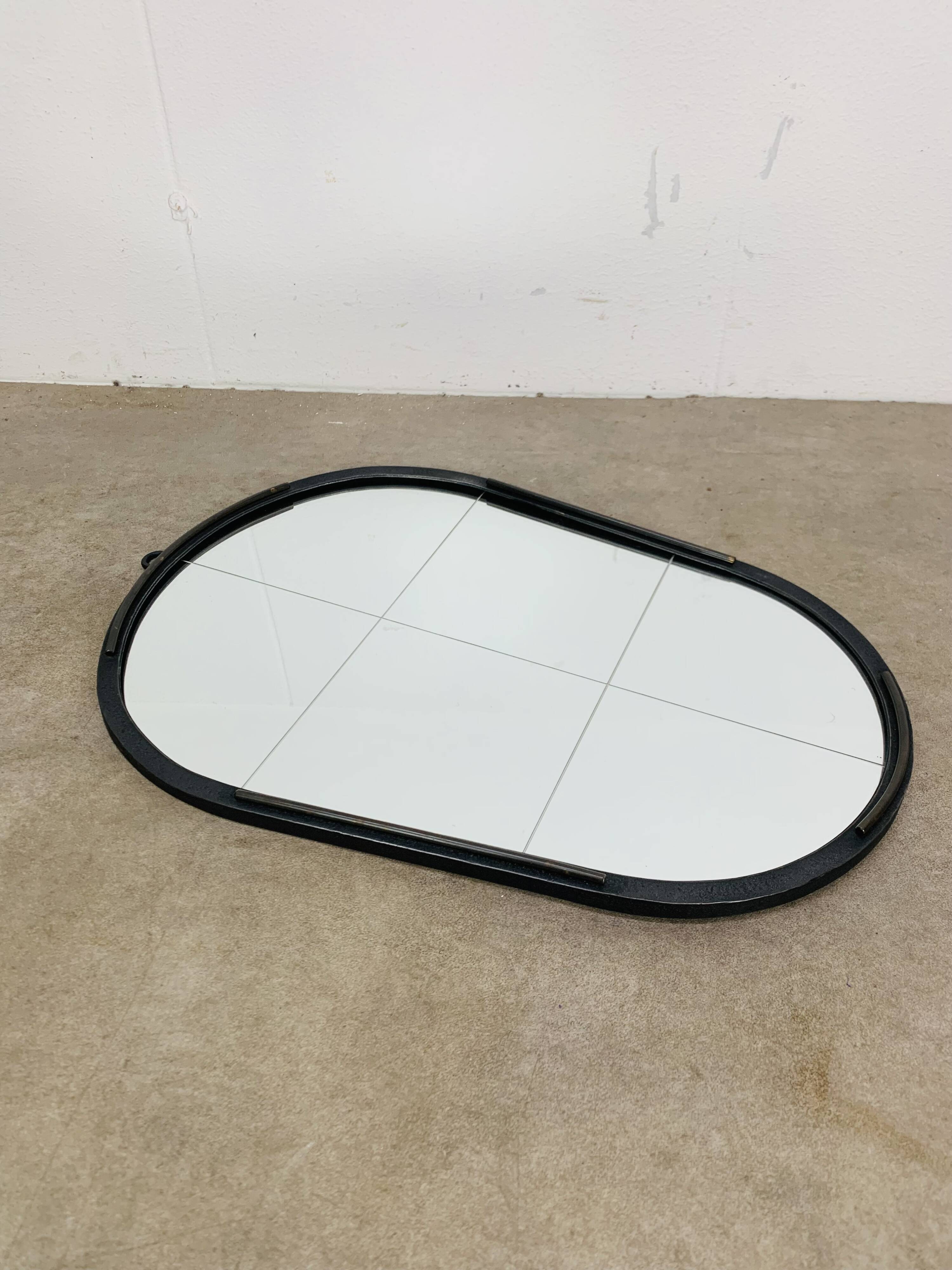 Oval mirror from the 1950s, wrought iron and brass.