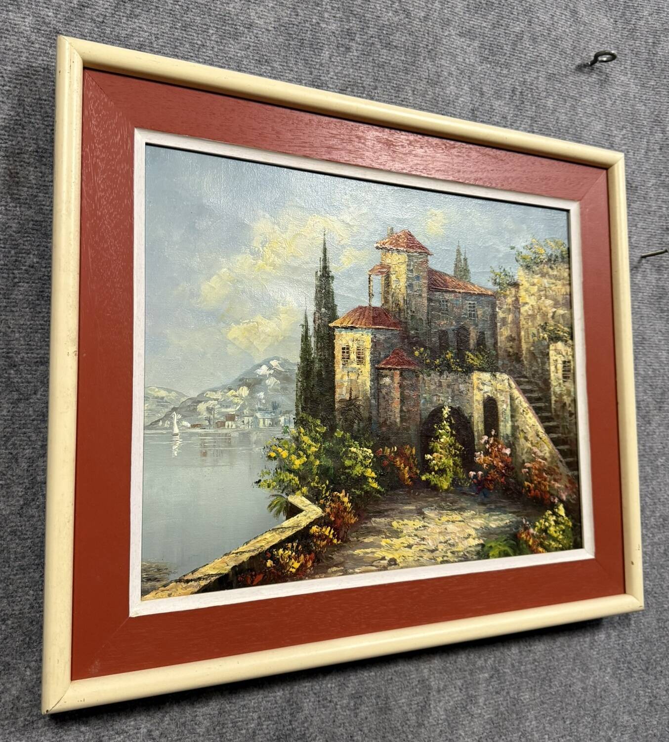 Italian School: painting of a castle on the edge of a lake